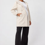 Front view of Ingrid & Isabel All-Weather Anorak Maternity Jacket in stone on a pregnant model.