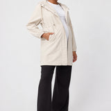Front view of Ingrid & Isabel All-Weather Anorak Maternity Jacket in stone on a pregnant model.