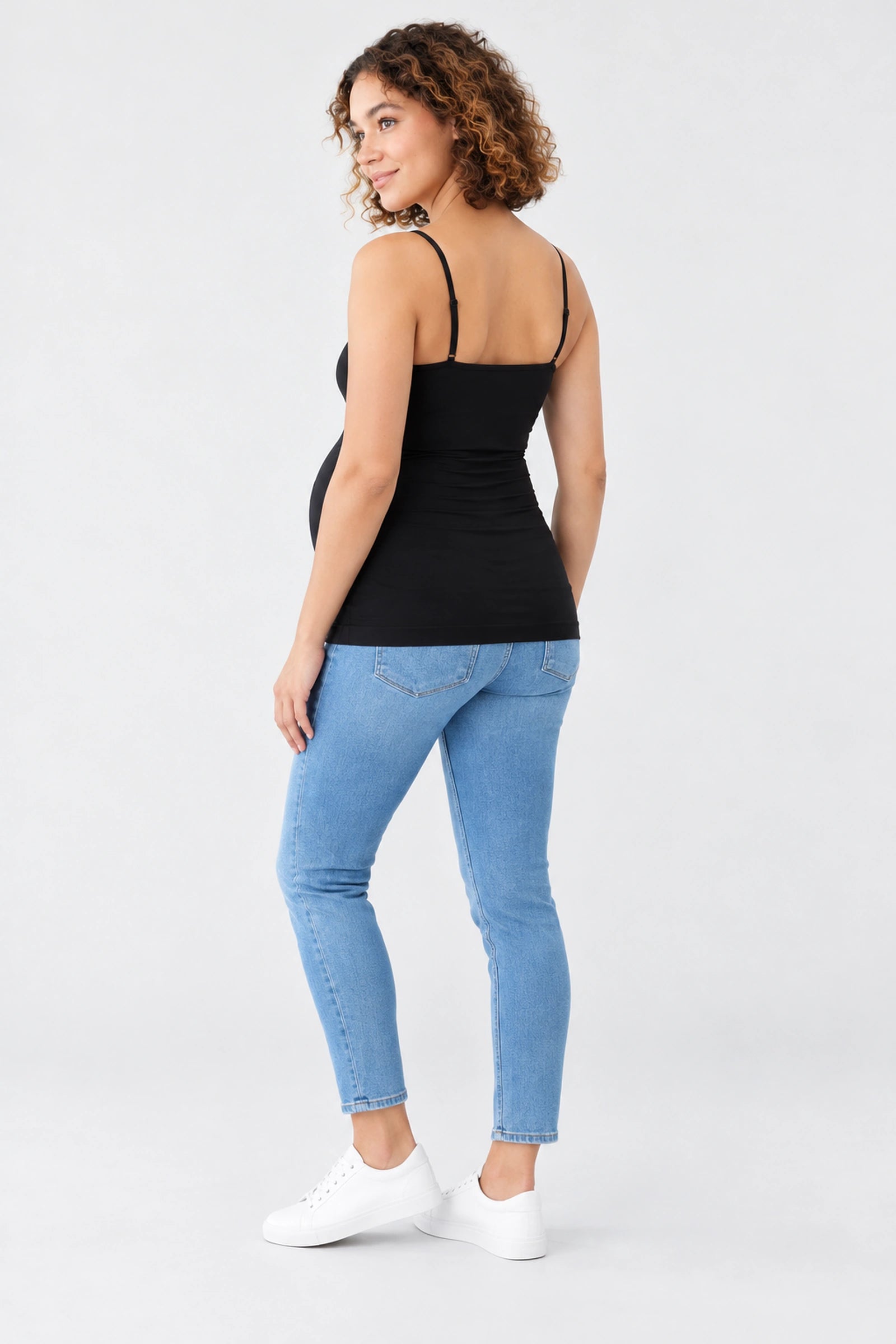 Back view of Ingrid & Isabel Cooling Maternity Layering Cami in black on a pregnant model.