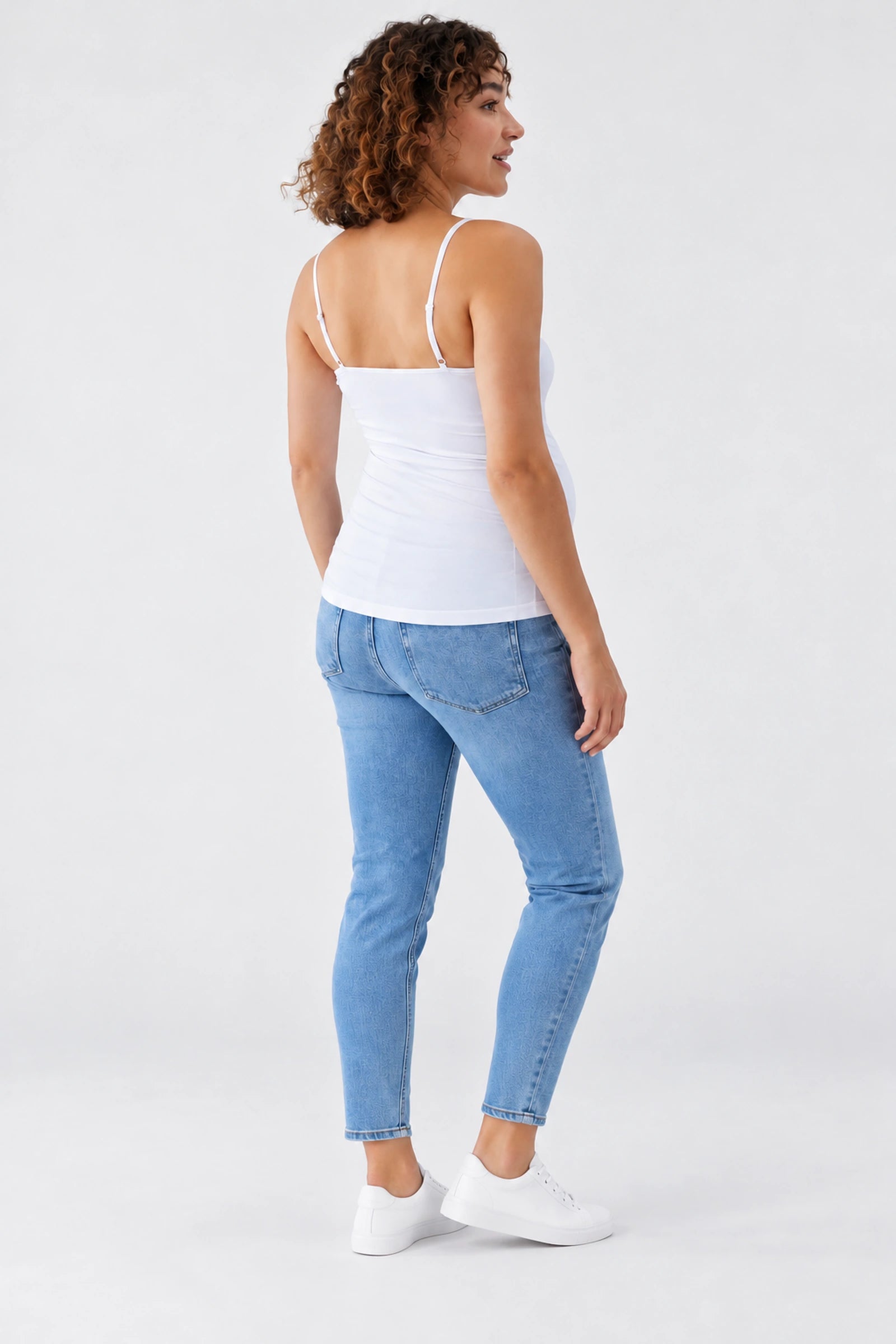 Back view of Ingrid & Isabel Cooling Maternity Layering Cami in white on a pregnant model.