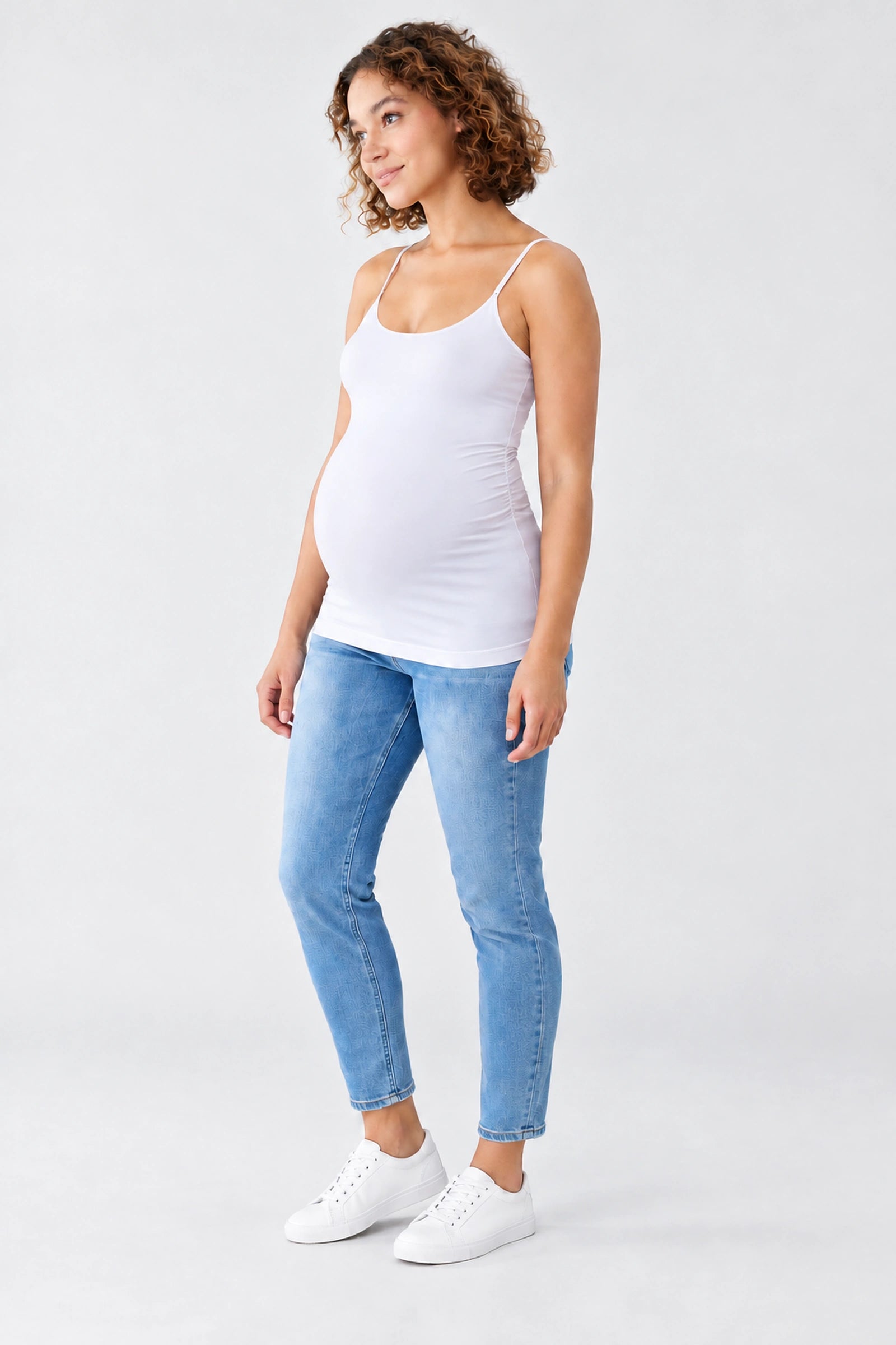 Front view of Ingrid & Isabel Cooling Maternity Layering Cami in white on a pregnant model.