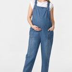 Front view of Ingrid & Isabel Everyday Denim Maternity Overalls in medium wash on a pregnant model.