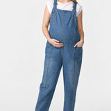 Front view of Ingrid & Isabel Everyday Denim Maternity Overalls in medium wash on a pregnant model.