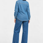 Back view of Ingrid & Isabel Relaxed Denim Maternity + Nursing Shirt in medium wash on a pregnant model.