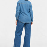 Back view of Ingrid & Isabel Relaxed Denim Maternity + Nursing Shirt in medium wash on a pregnant model.
