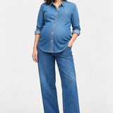 Front view of Ingrid & Isabel Relaxed Denim Maternity + Nursing Shirt in medium wash on a pregnant model.