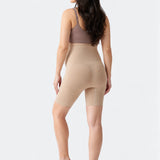 Back view of Ingrid & Isabel Seamless Maternity Shapewear Shortie in taupe on a pregnant model.