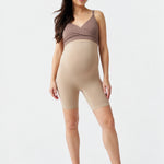 Front view of Ingrid & Isabel Seamless Maternity Shapewear Shortie in taupe on a pregnant model.