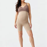 Front view of Ingrid & Isabel Seamless Maternity Shapewear Shortie in taupe on a pregnant model.