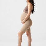 Side view of Ingrid & Isabel Seamless Maternity Shapewear Shortie in taupe on a pregnant model.