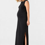 Side view of Ingrid & Isabel The Sidekick Maternity Column Dress in black on a pregnant model.