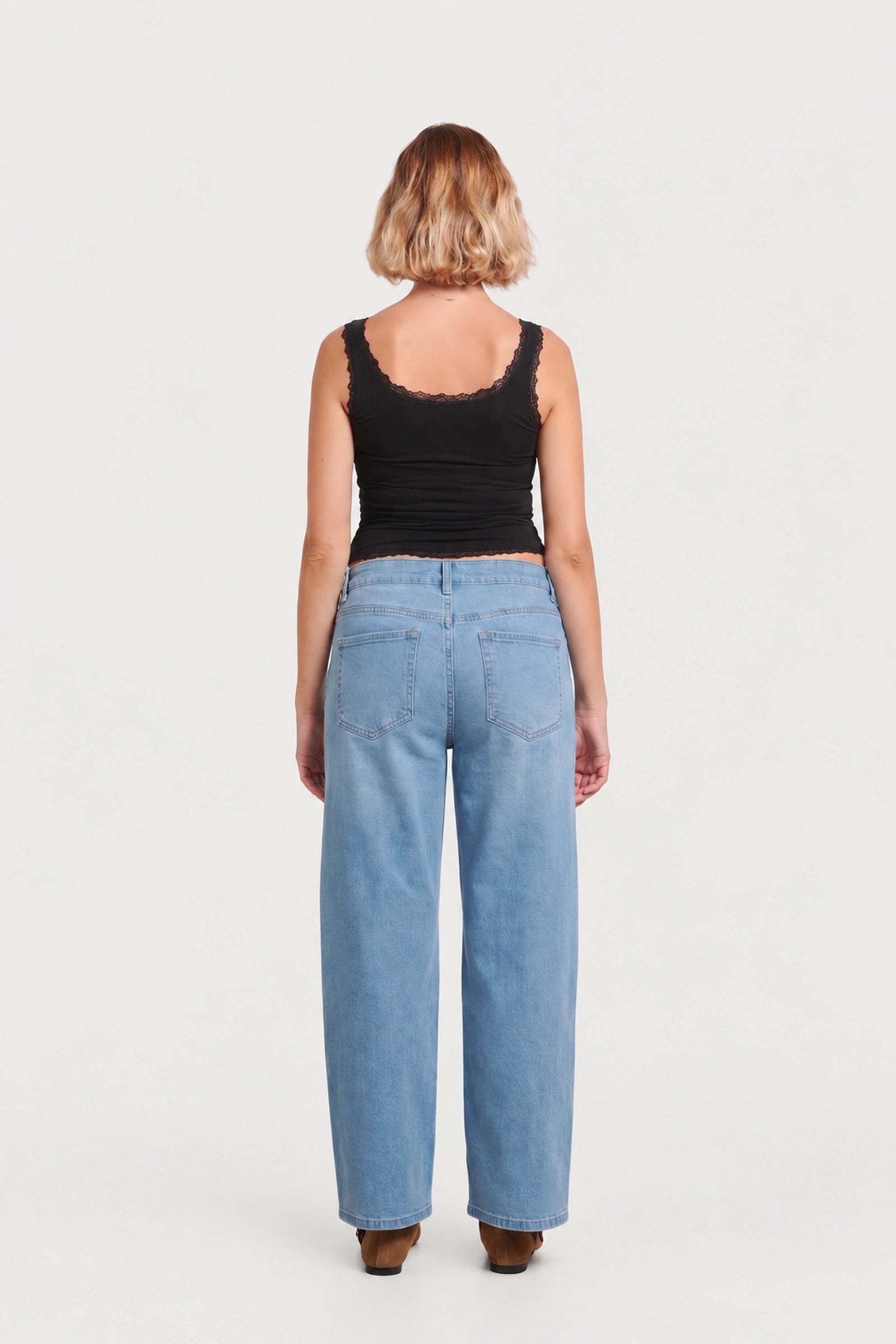 Back view of NOM Slouch Under-Bump Relaxed Jeans — Light Wash