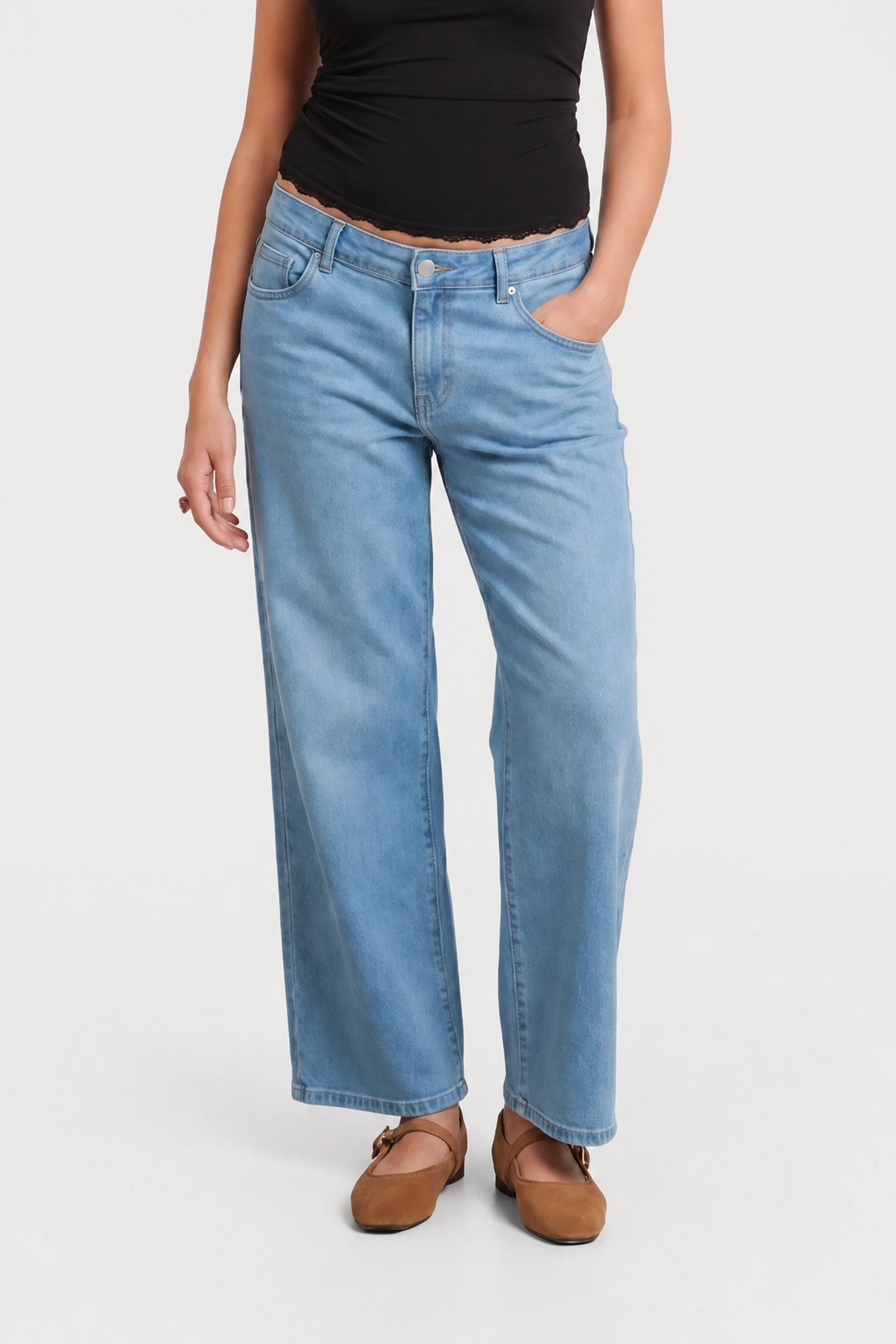 Detail view of NOM Slouch Under-Bump Relaxed Jeans — Light Wash