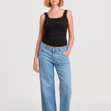 Front view of NOM Slouch Under-Bump Relaxed Jeans — Light Wash
