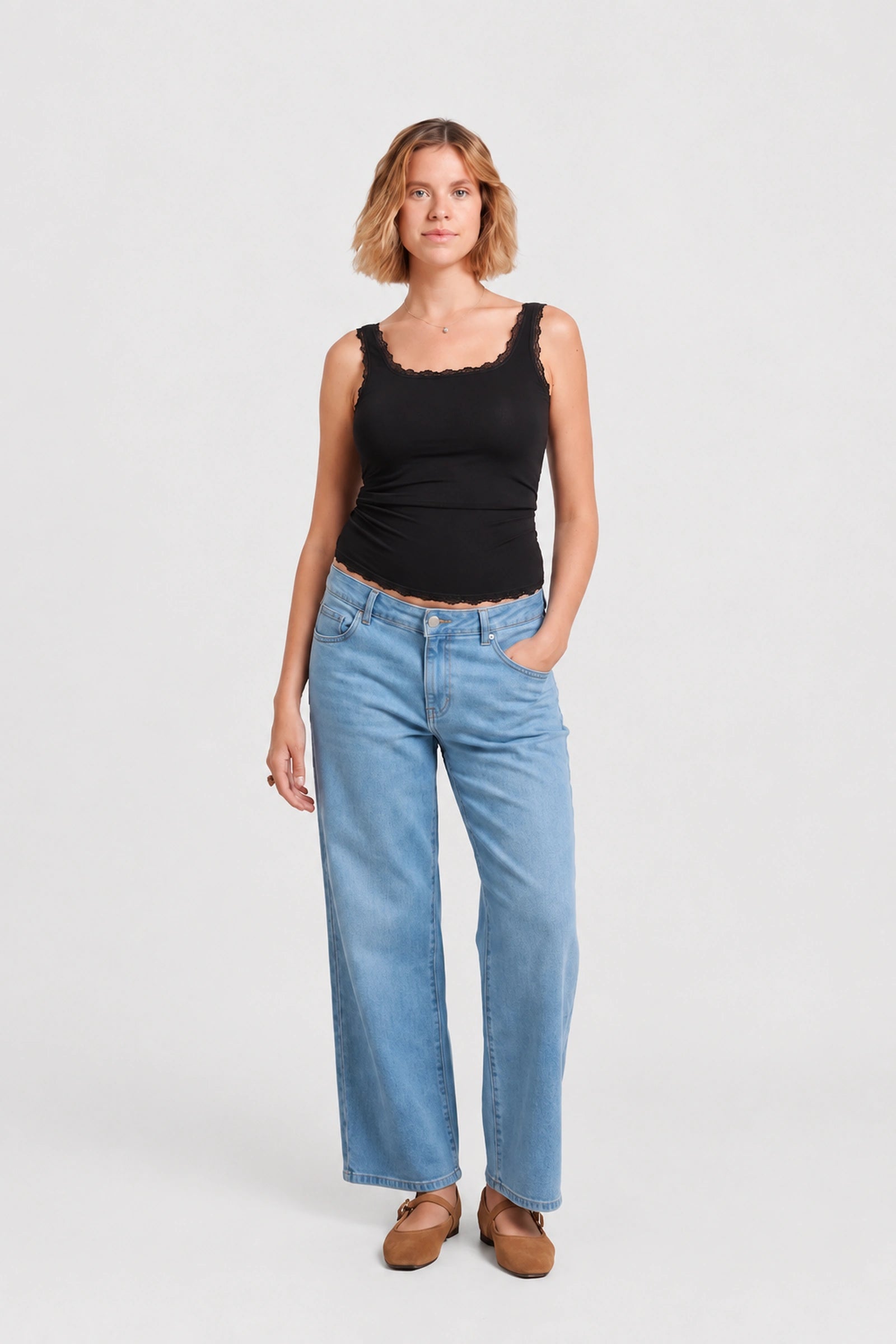 Front view of NOM Slouch Under-Bump Relaxed Jeans — Light Wash
