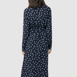 Detail of back of Spot shirt dress in navy with white polka dots. For maternity and nursing with button access for nursing and tie empire waist. Long sleeves and calf-length dress cut. 