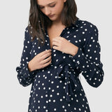 Detail showing nursing access buttons at bodice on Spot shirt dress in navy with white polka dots. For maternity and nursing with button access for nursing and tie empire waist. Long sleeves and calf-length dress cut. 