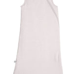 Baby wearing Kyte Baby Sleep sack in 1.0 TOG weight in light brown oat color