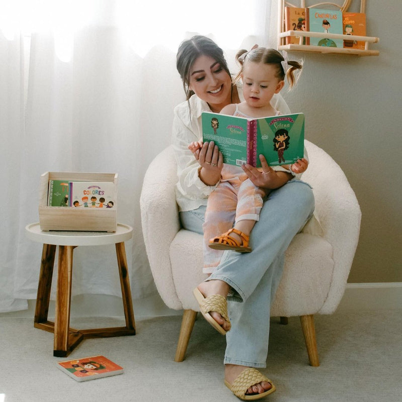 Mother and child reading La Vida de Selena bilingual board book together