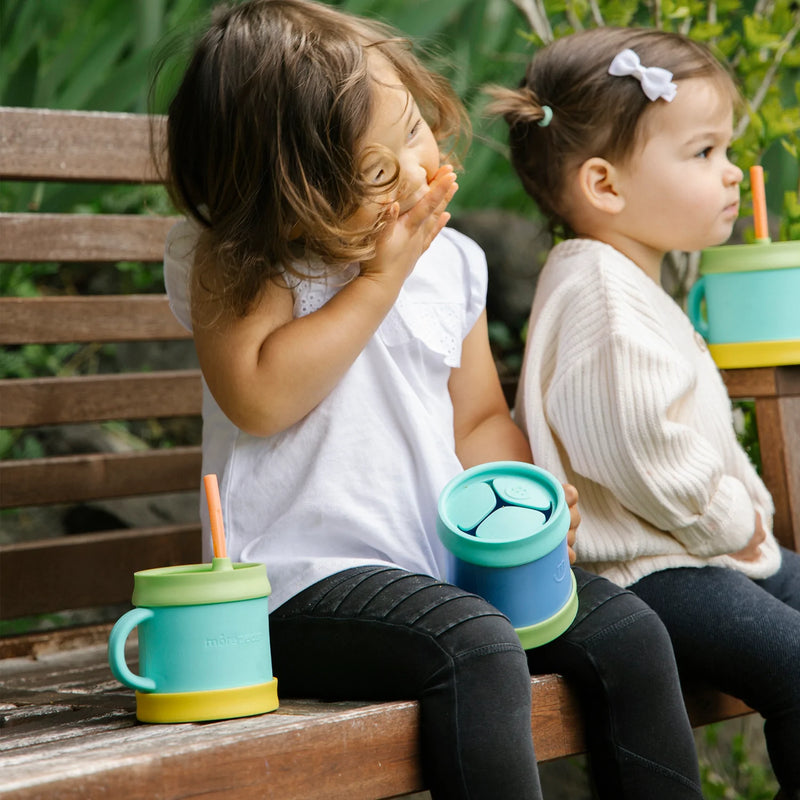 Children using morepeas essential sippy cup and snack cup. 