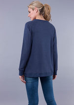 Blue crossover maternity and nursing sweater with tulip shaped hem that pull-aside as layers for nursing access - reverse view with straight hem on rear